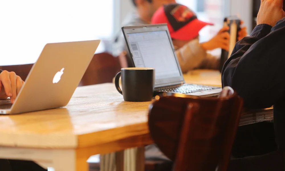 people using their laptops at a coffee shop