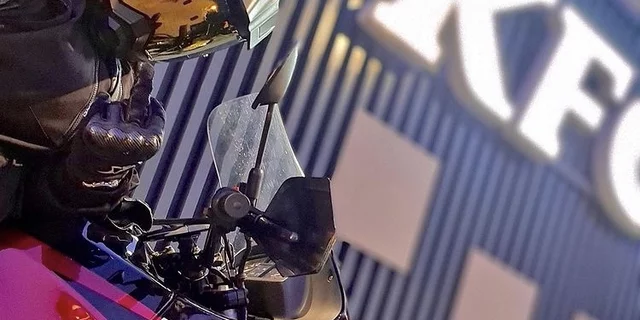 A motorcyclist holding up his middle finger