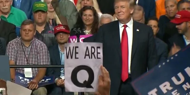 QAnon appearing at Trump rallies. 